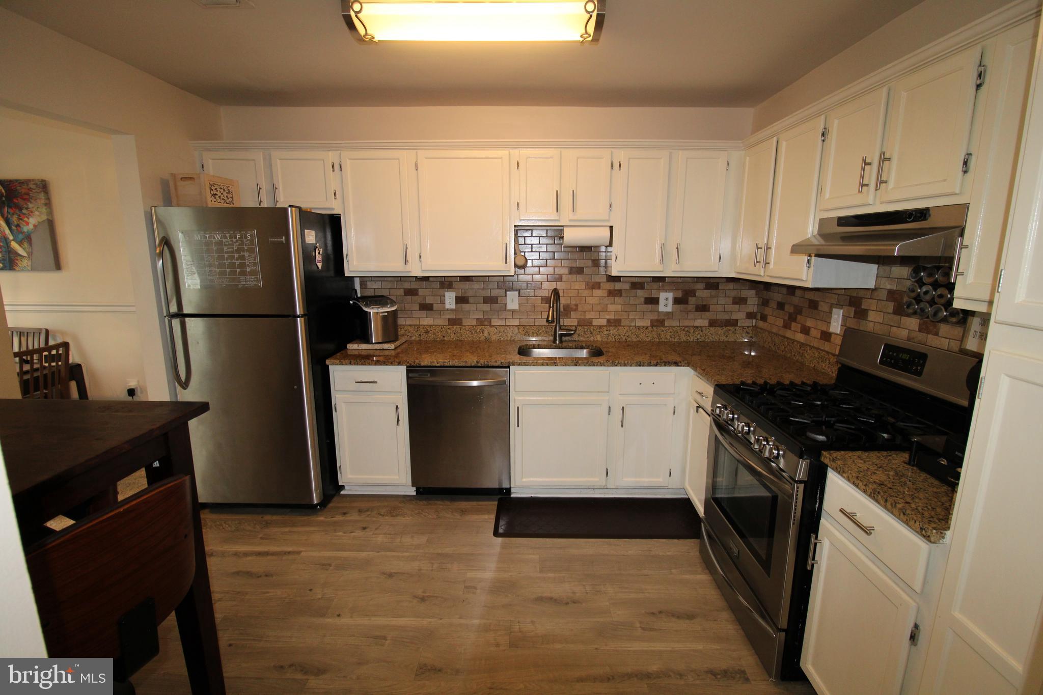 7863 Apache Ridge Court Manassas, VA 20109 - Photo 12 of 38 a kitchen with a sink stove and refrigerator
