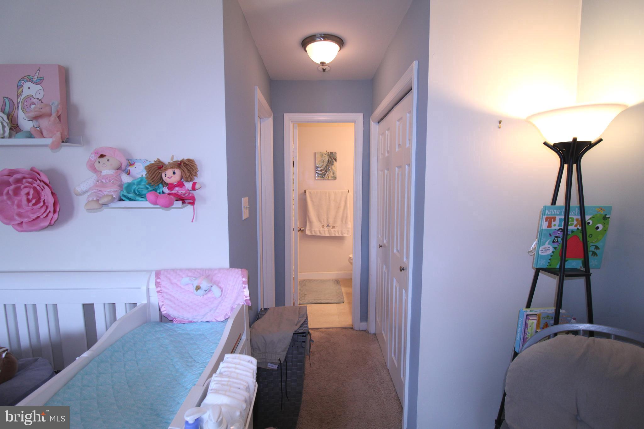 7863 Apache Ridge Court Manassas, VA 20109 - Photo 19 of 38 a bedroom with a bed and a chandelier