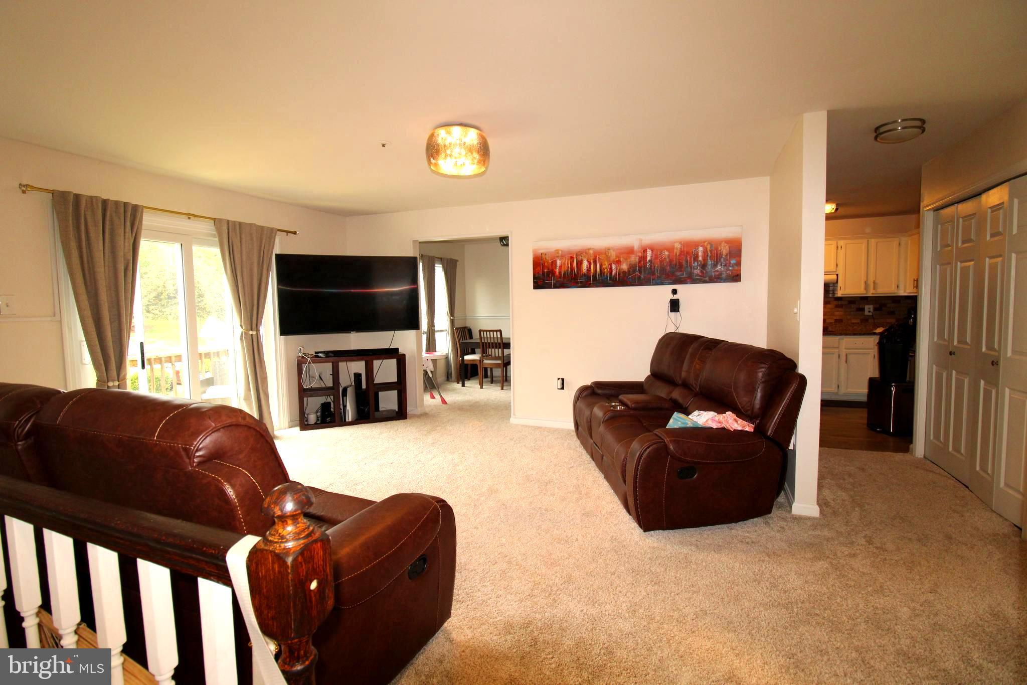 7863 Apache Ridge Court Manassas, VA 20109 - Photo 6 of 38 a living room with furniture and a flat screen tv