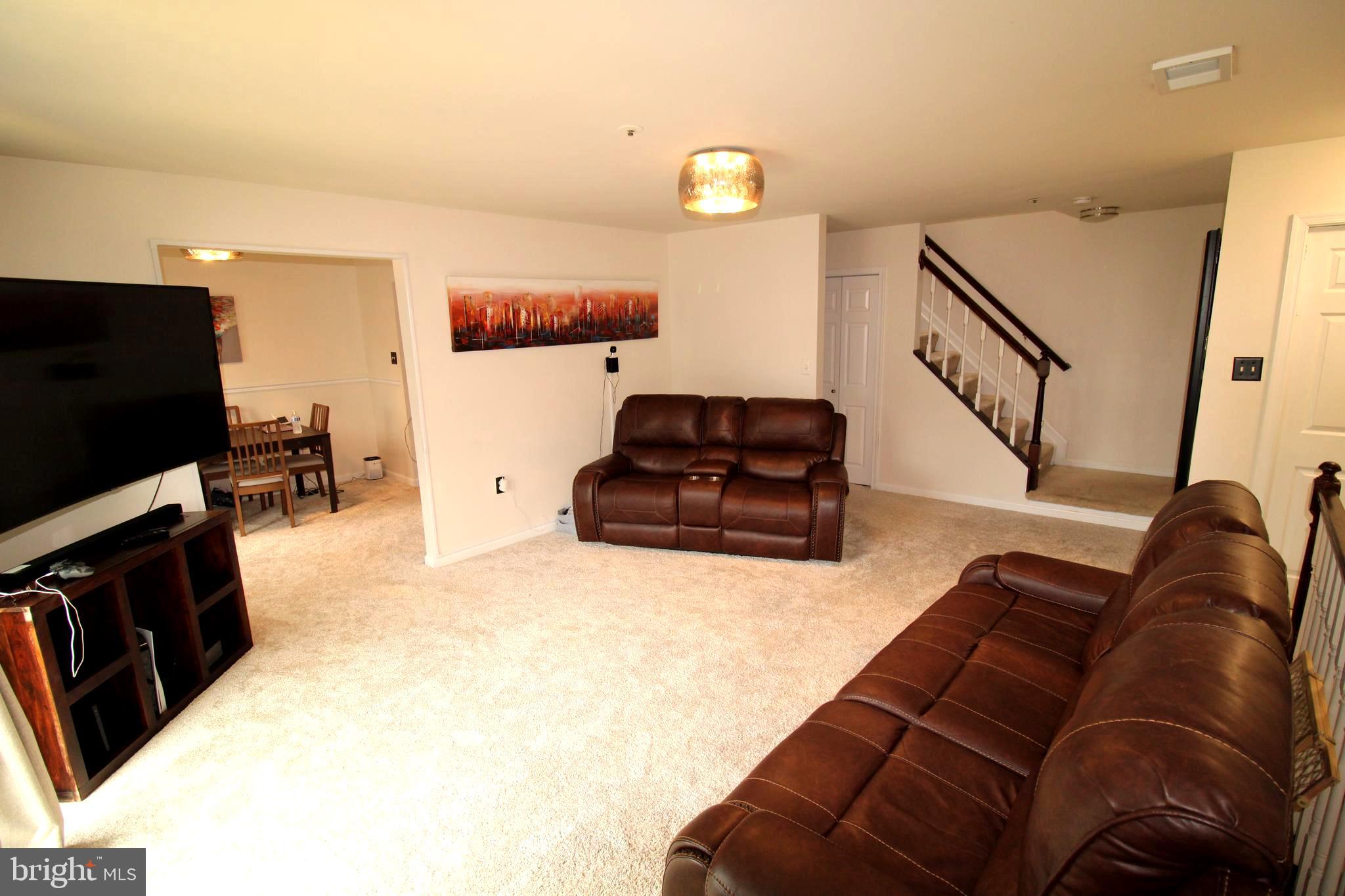 7863 Apache Ridge Court Manassas, VA 20109 - Photo 8 of 38 a living room with furniture and a flat screen tv