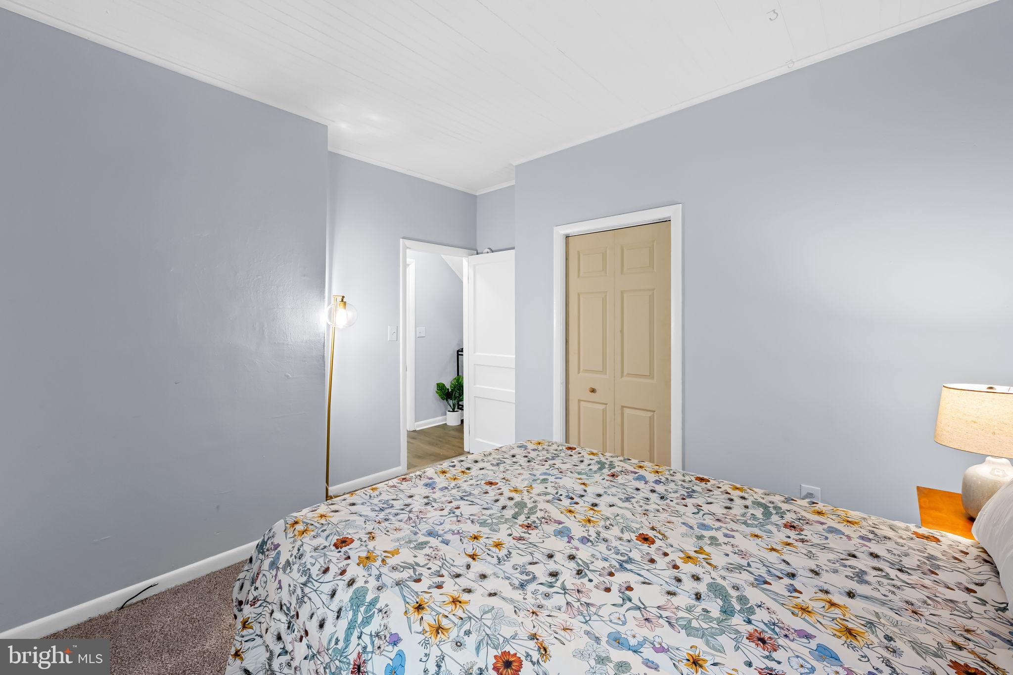 735 Main Street Delta, PA 17314 - Photo 17 of 35 a bedroom with a bed and a lamp