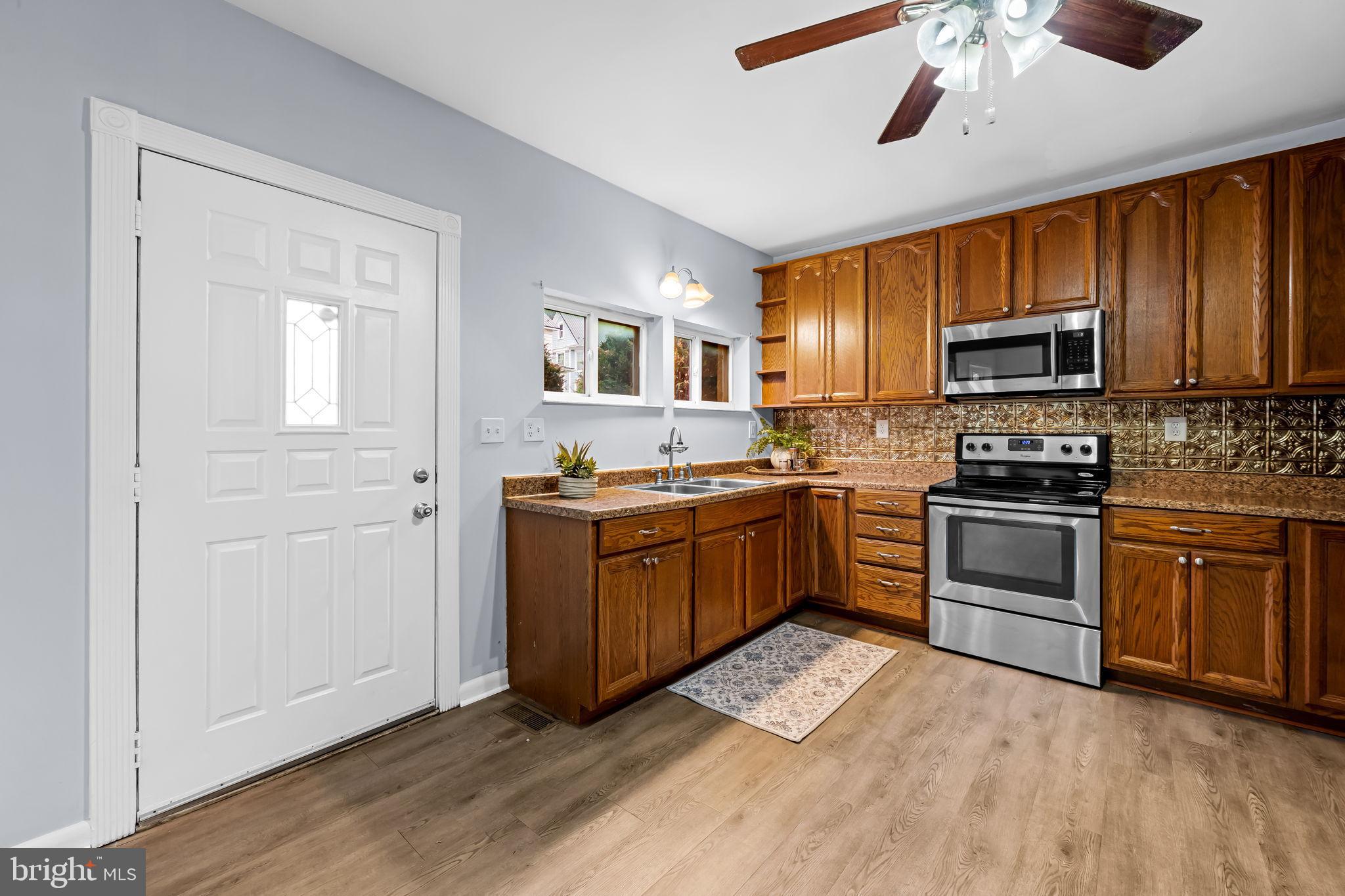 735 Main Street Delta, PA 17314 - Photo 9 of 35 a kitchen with granite countertop a refrigerator and a stove top oven