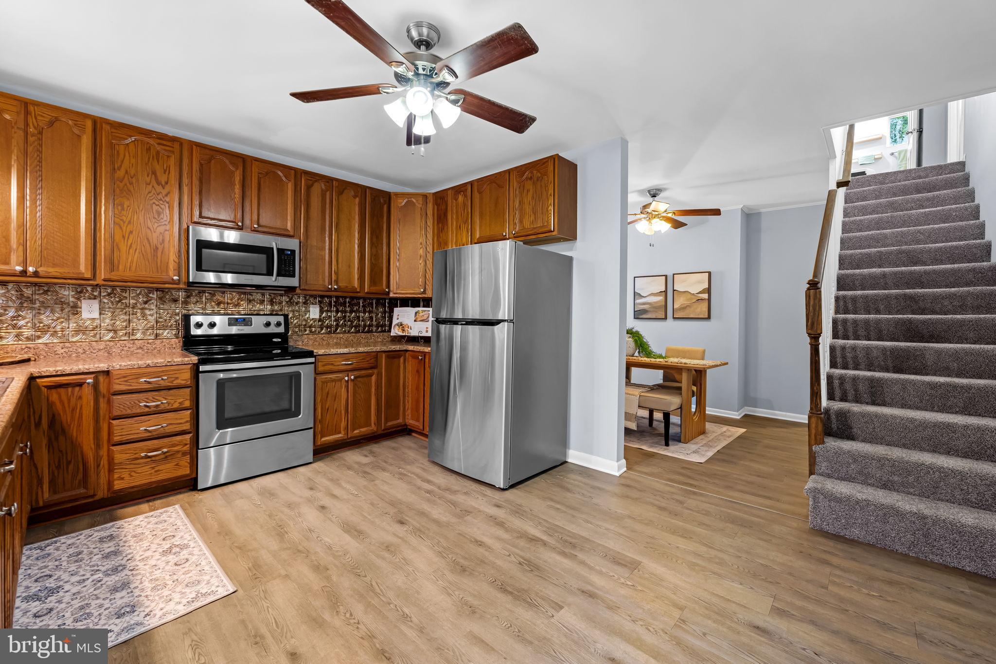 735 Main Street Delta, PA 17314 - Photo 10 of 35 a kitchen with a refrigerator cabinets and wooden floor