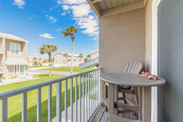 a view of a dining room with furniture and a chandelier