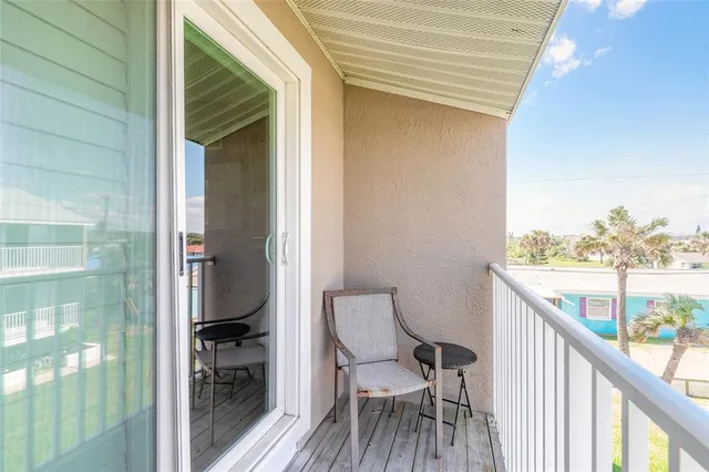 a balcony with table and chairs