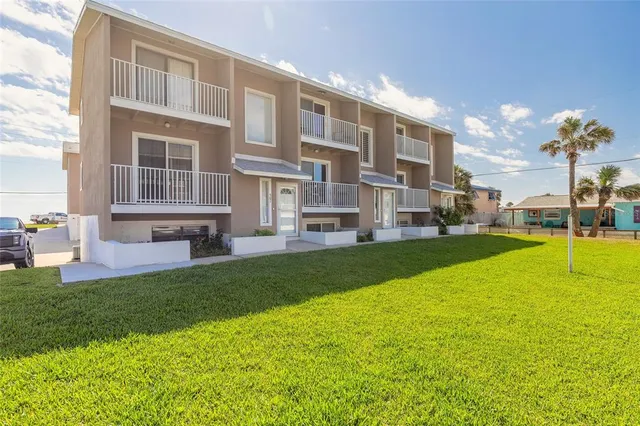 a view of an apartment with a backyard