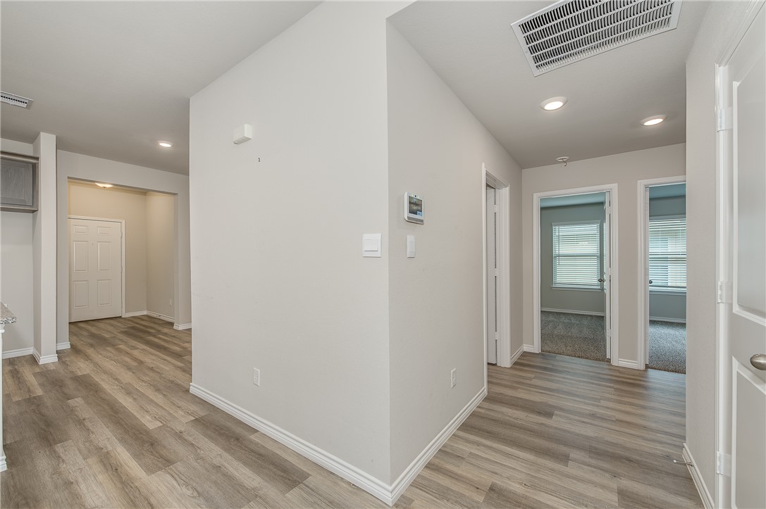 2166 Chief Street Bryan, TX 77807 - Photo 10 of 18 a view of a hallway with wooden floor and staircase
