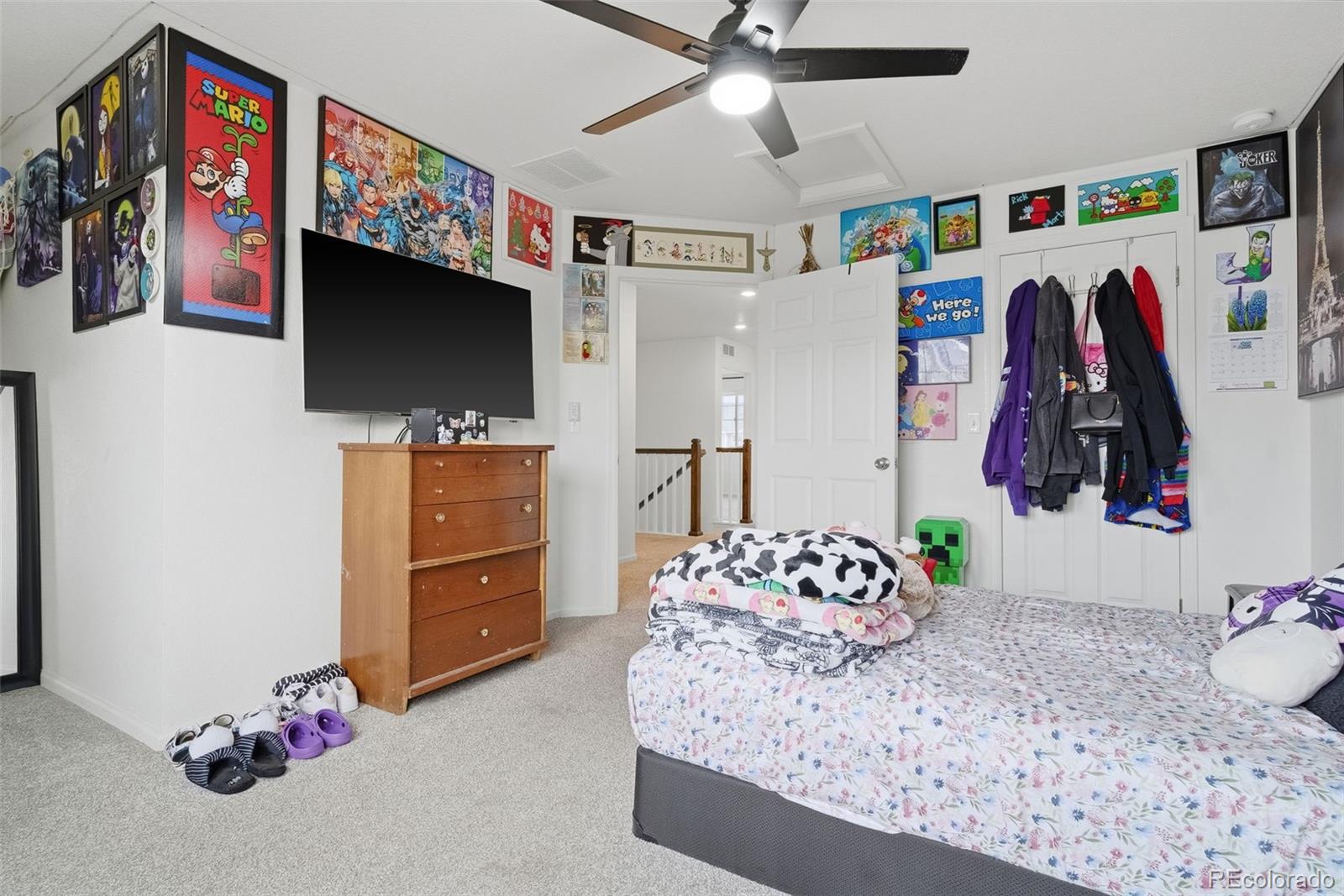 5017 Liverpool Street Denver, CO 80249 - Photo 27 of 42 a bedroom with a bed and a flat screen tv