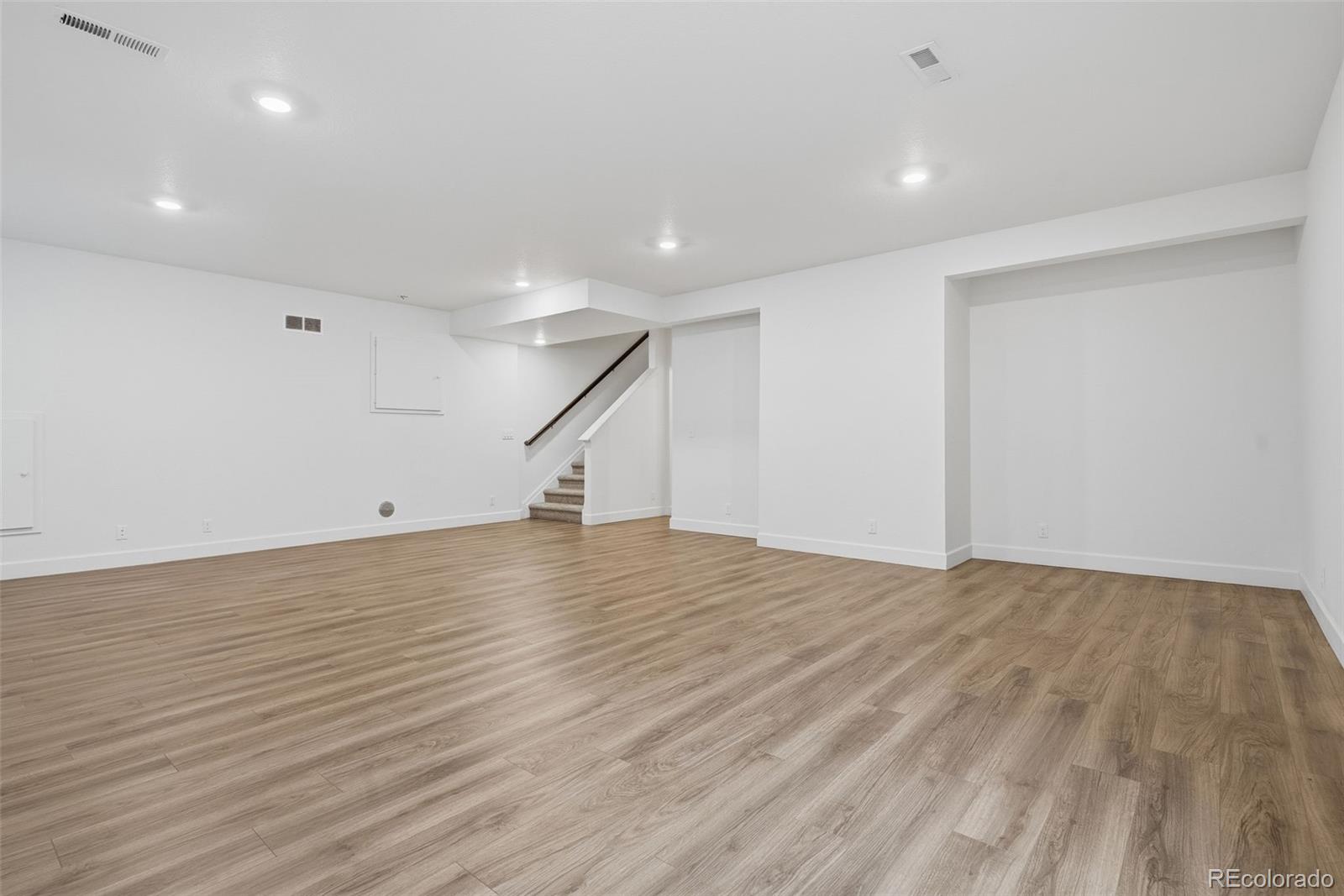 5017 Liverpool Street Denver, CO 80249 - Photo 31 of 42 a view of an empty room with wooden floor