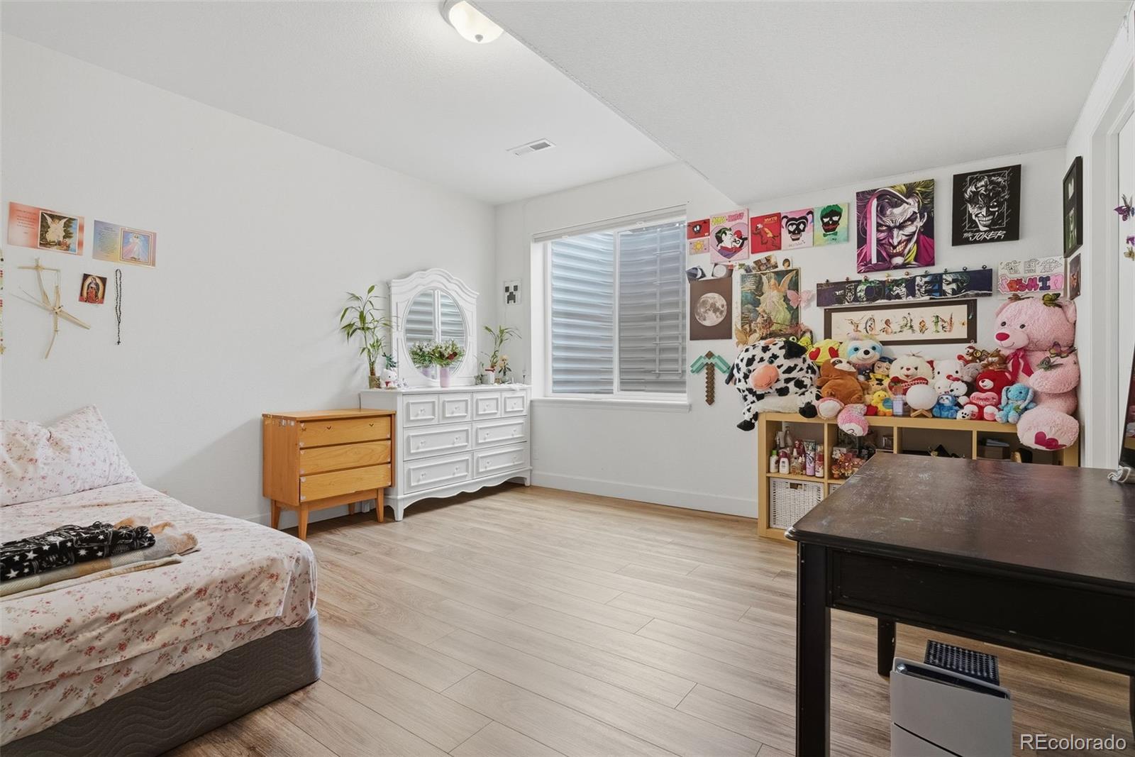 5017 Liverpool Street Denver, CO 80249 - Photo 33 of 42 a bedroom with furniture and a bed