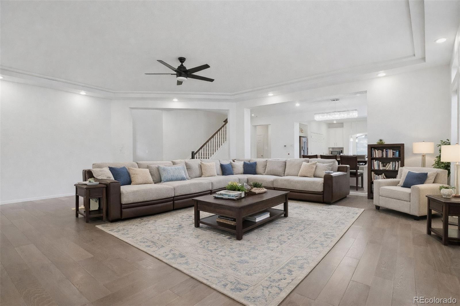 5017 Liverpool Street Denver, CO 80249 - Photo 7 of 42 a living room with furniture and a ceiling fan