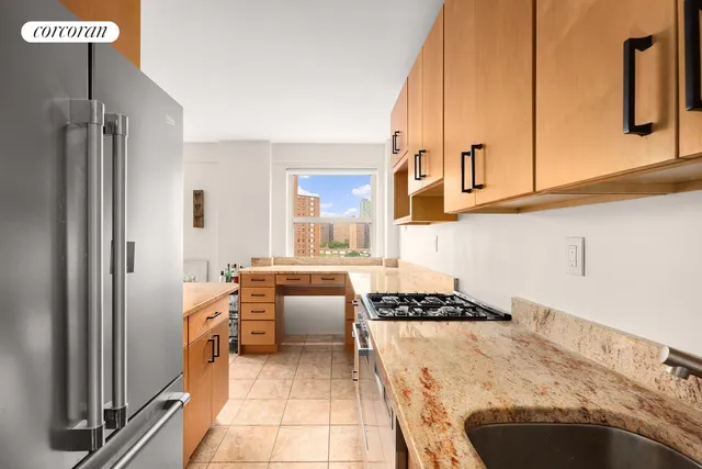 a kitchen with stainless steel appliances a sink counter top space