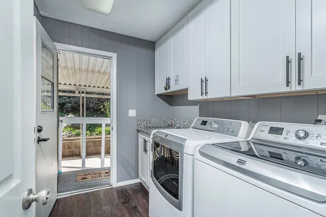 a view of a livingroom with a ceiling fan & windows