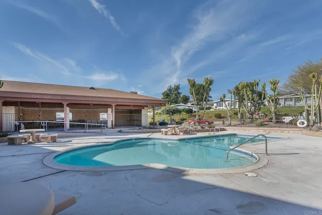 a view of a livingroom with a lots of windows and wooden floor