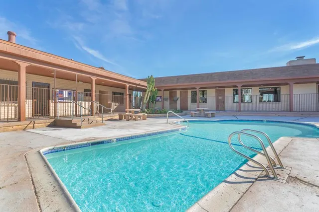 a living room with fireplace furniture and a large window
