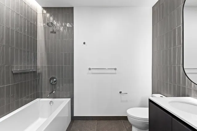 a bathroom with a sink a toilet and mirror