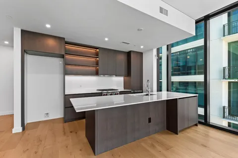 a kitchen with granite countertop a stove and a refrigerator