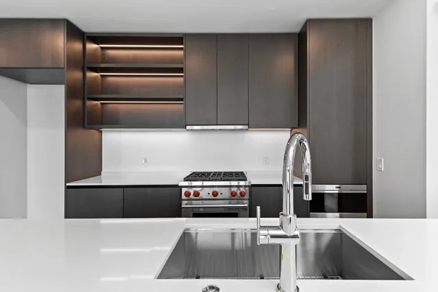a stove top oven sitting inside of a kitchen