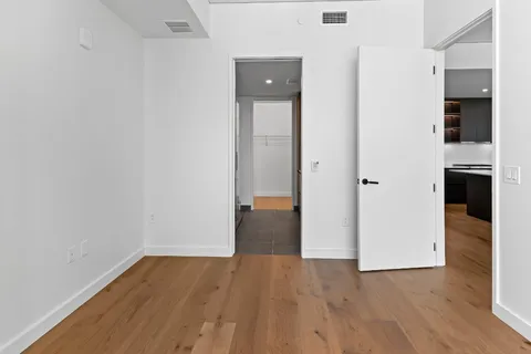 a bathroom with a double vanity sink a mirror and a shower