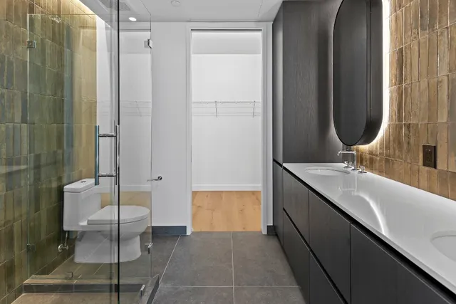 a bathroom with a double vanity sink and a mirror