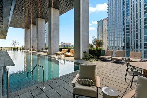 a view of a swimming pool with outdoor seating
