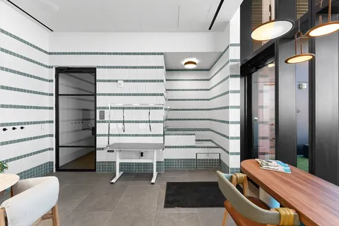 a dining room with furniture and a potted plant