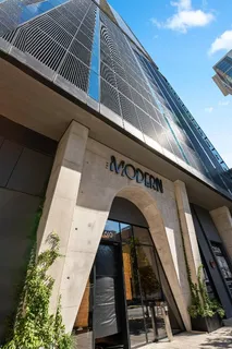 a building outdoor space with patio furniture and potted plants