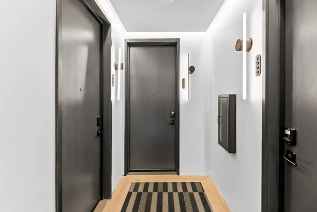 a view of a hallway with wooden shelves