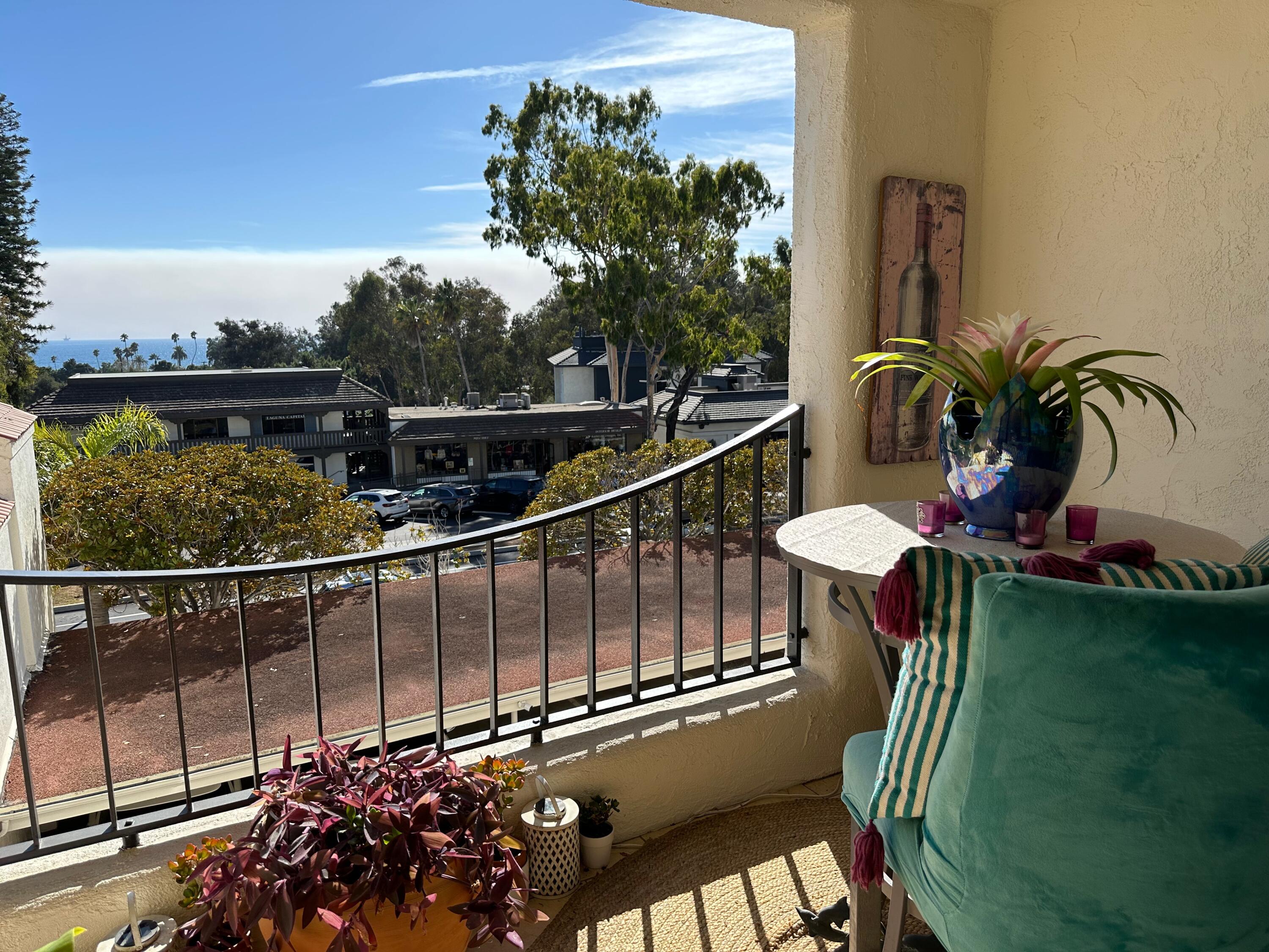 1220 Coast Village Road, Unit 208 Montecito, CA 93108 - Photo 4 of 11 a view of a balcony with chairs and potted plant