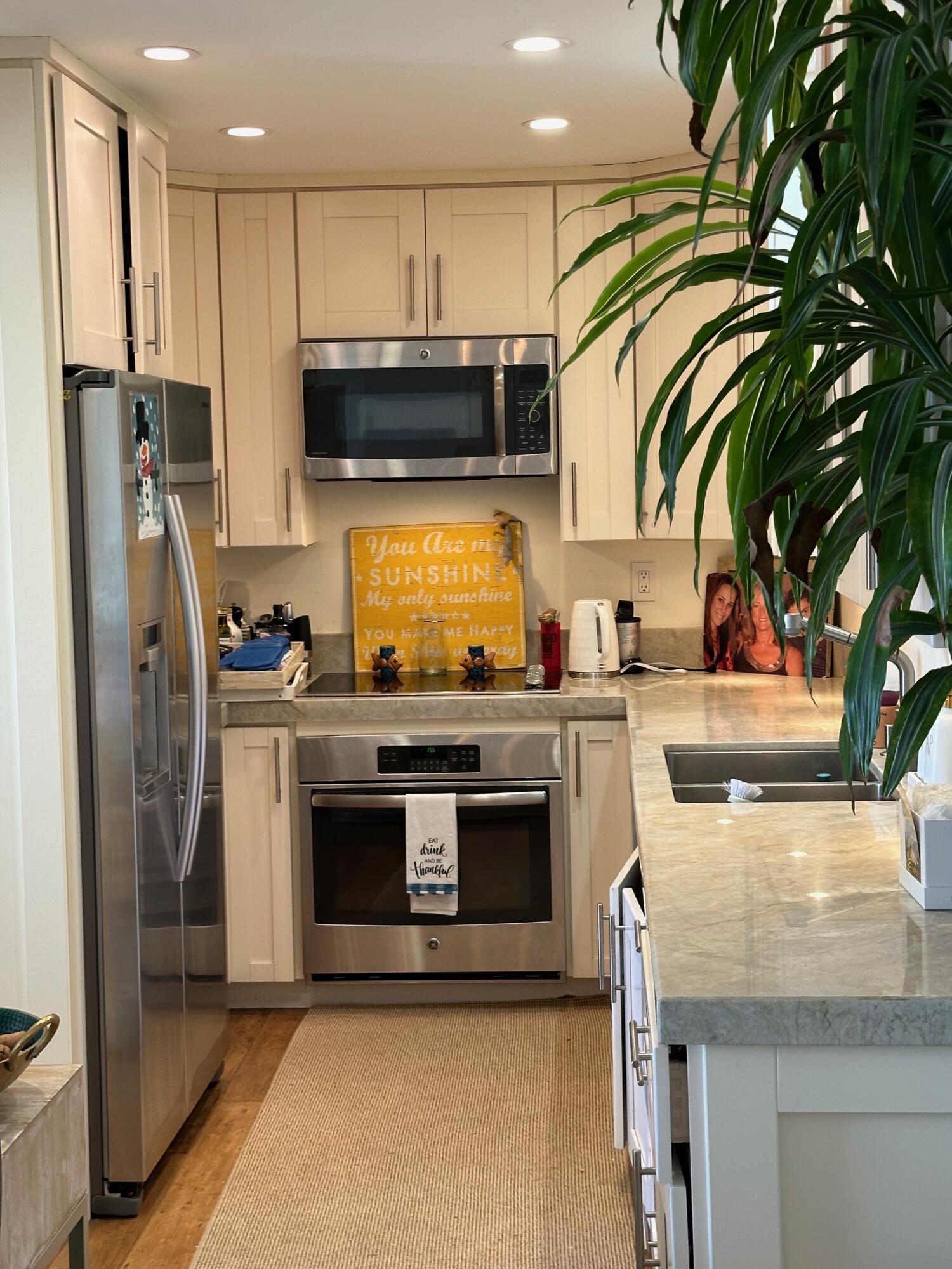 1220 Coast Village Road, Unit 208 Montecito, CA 93108 - Photo 5 of 11 a kitchen with stainless steel appliances granite countertop a stove a refrigerator and a oven