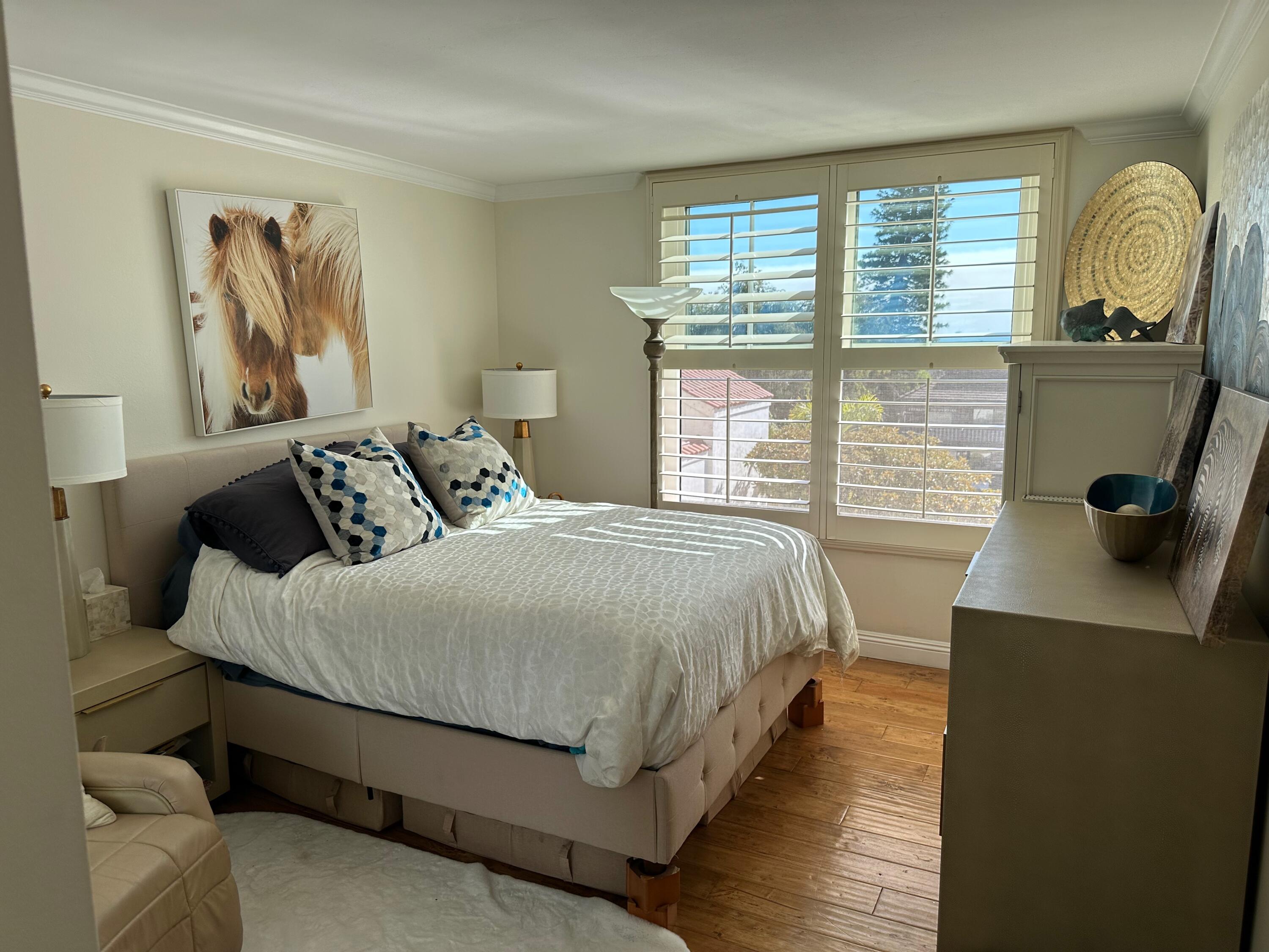 1220 Coast Village Road, Unit 208 Montecito, CA 93108 - Photo 8 of 11 a bedroom with a bed and window