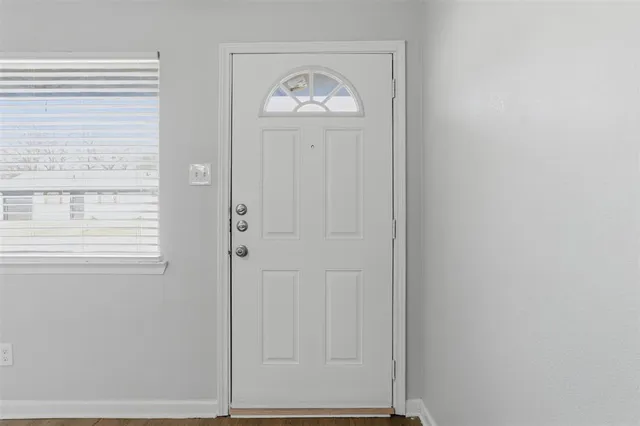 a view of an entryway with wooden floor