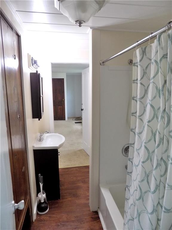 836 Little Summit Road Vanderbilt, PA 15486 - Photo 12 of 14 a bathroom with a sink and mirror with bathtub