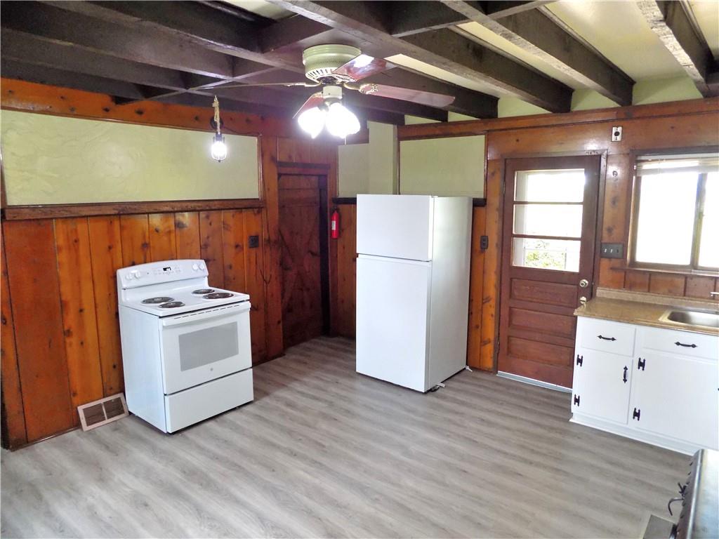 836 Little Summit Road Vanderbilt, PA 15486 - Photo 6 of 14 a kitchen with a refrigerator and white cabinets