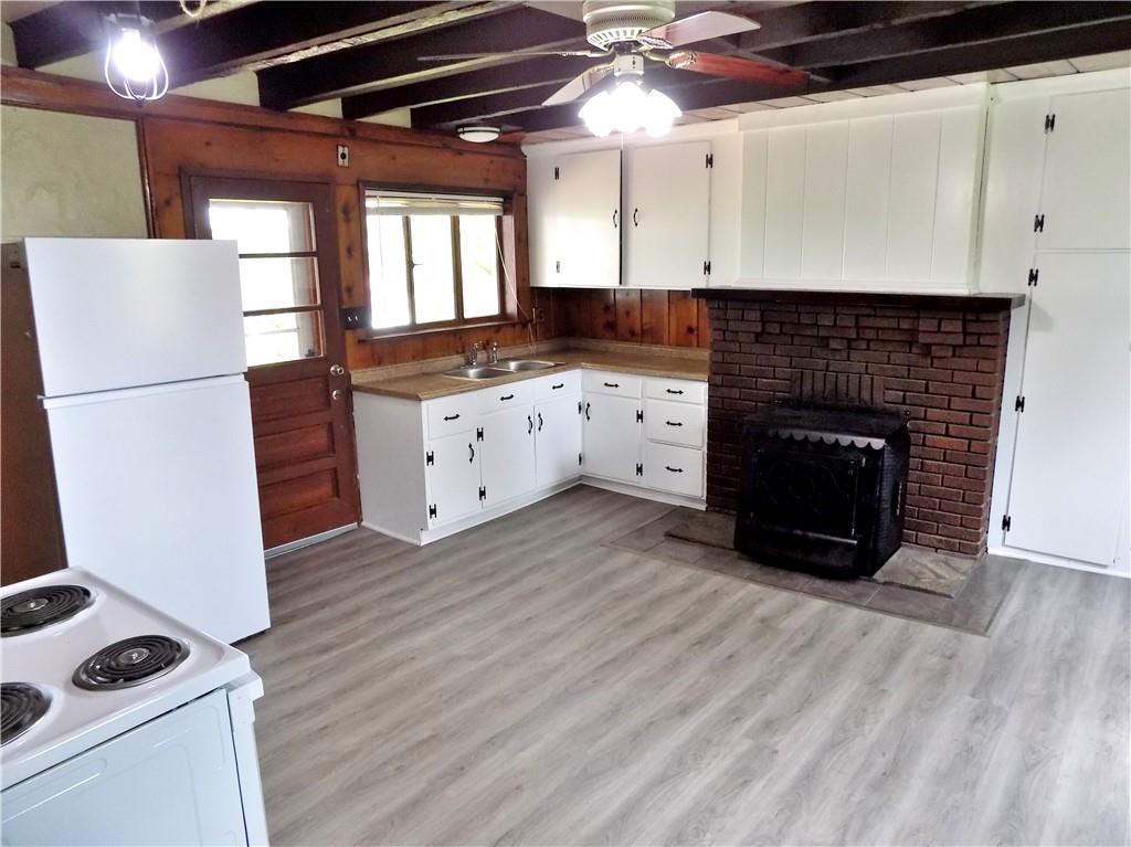 836 Little Summit Road Vanderbilt, PA 15486 - Photo 7 of 14 a kitchen with granite countertop a refrigerator and a stove