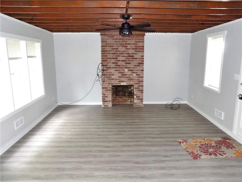 836 Little Summit Road Vanderbilt, PA 15486 - Photo 9 of 14 a view of empty room with wooden floor and fireplace