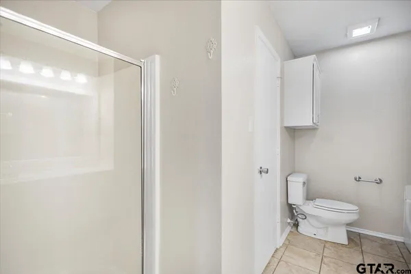 an empty room with a ceiling fan and window