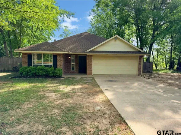 a front view of house with yard and trees