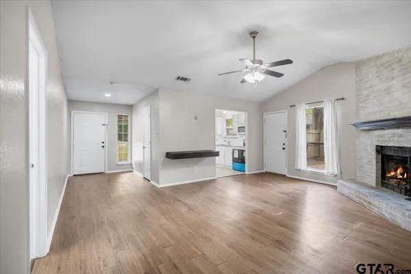 a kitchen with stainless steel appliances granite countertop a sink a stove a microwave and cabinets
