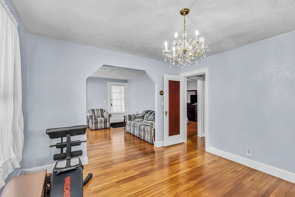 44 Cherrelyn Street Springfield, MA 01104 - Photo 15 of 36 a view of a livingroom with chandelier and wooden floor