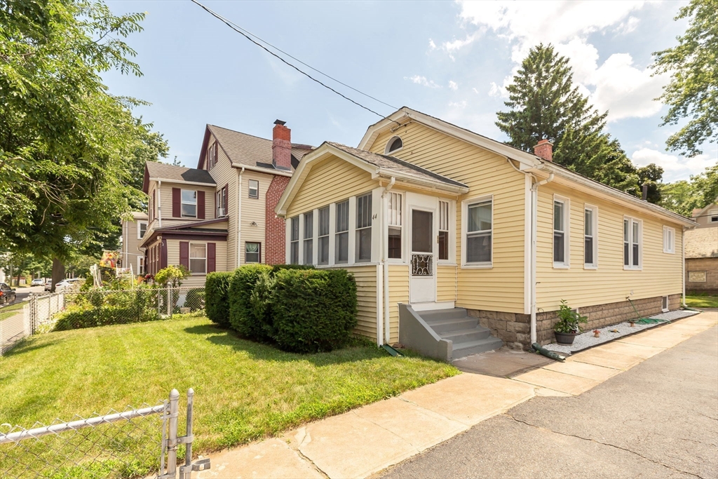44 Cherrelyn Street Springfield, MA 01104 - Photo 2 of 36 a view of a white house with a large windows and a yard