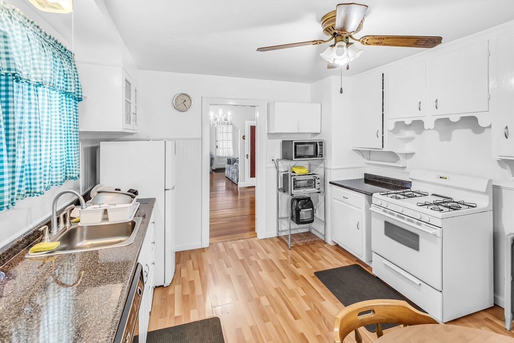 44 Cherrelyn Street Springfield, MA 01104 - Photo 22 of 36 a kitchen with stainless steel appliances granite countertop a sink stove and refrigerator
