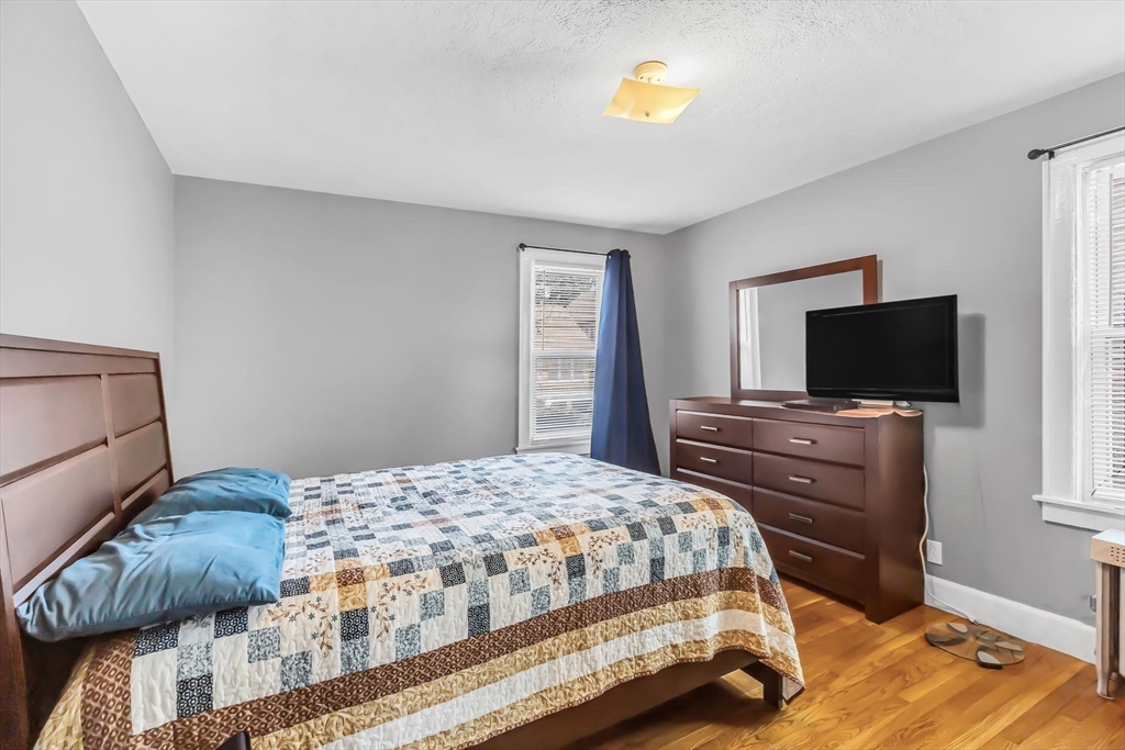 44 Cherrelyn Street Springfield, MA 01104 - Photo 23 of 36 a bedroom with a bed and a flat screen tv