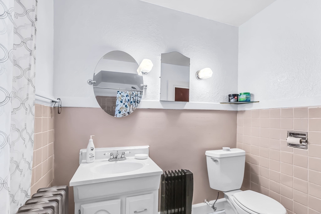 44 Cherrelyn Street Springfield, MA 01104 - Photo 25 of 36 a bathroom with a toilet sink and mirror