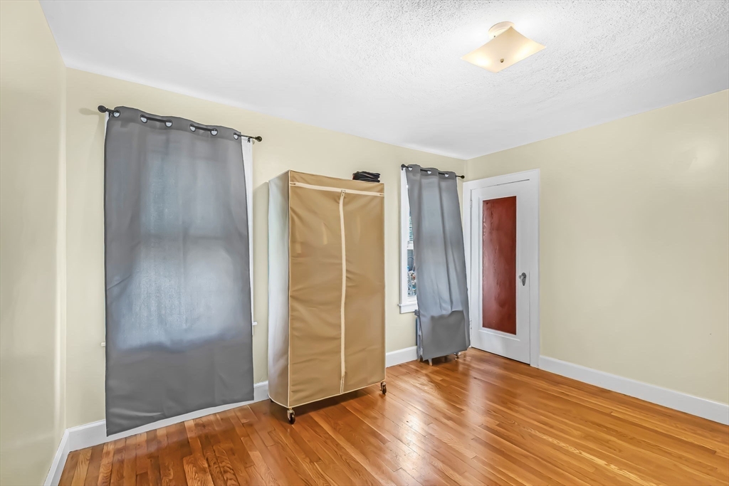 44 Cherrelyn Street Springfield, MA 01104 - Photo 28 of 36 an empty room with wooden floor and windows