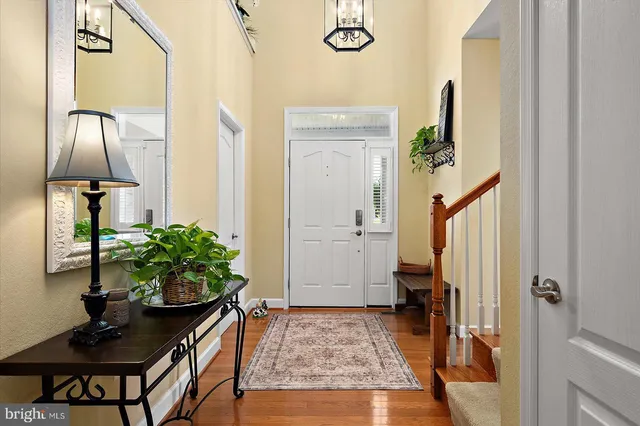 a bedroom with a bed couch and a chandelier