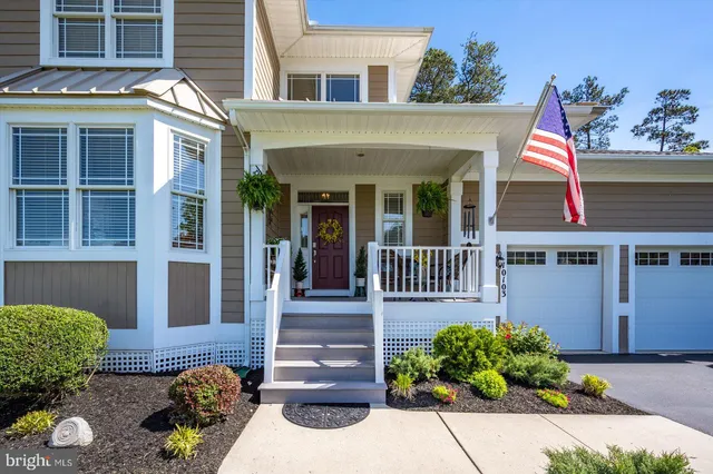an aerial view of a house with a swimming pool outdoor seating and yard