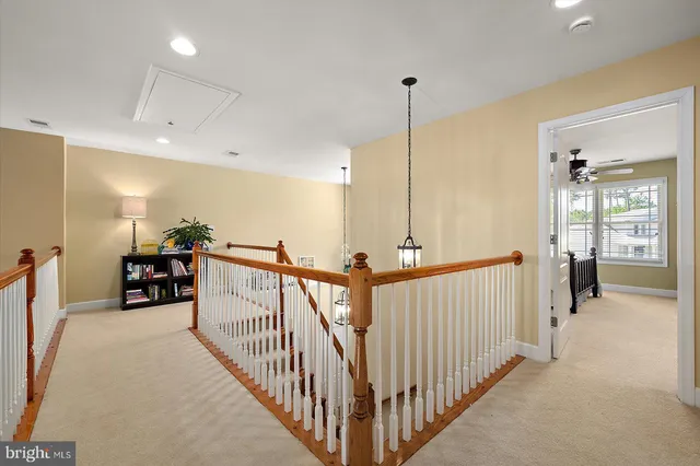 an aerial view of a house with swimming pool and large trees