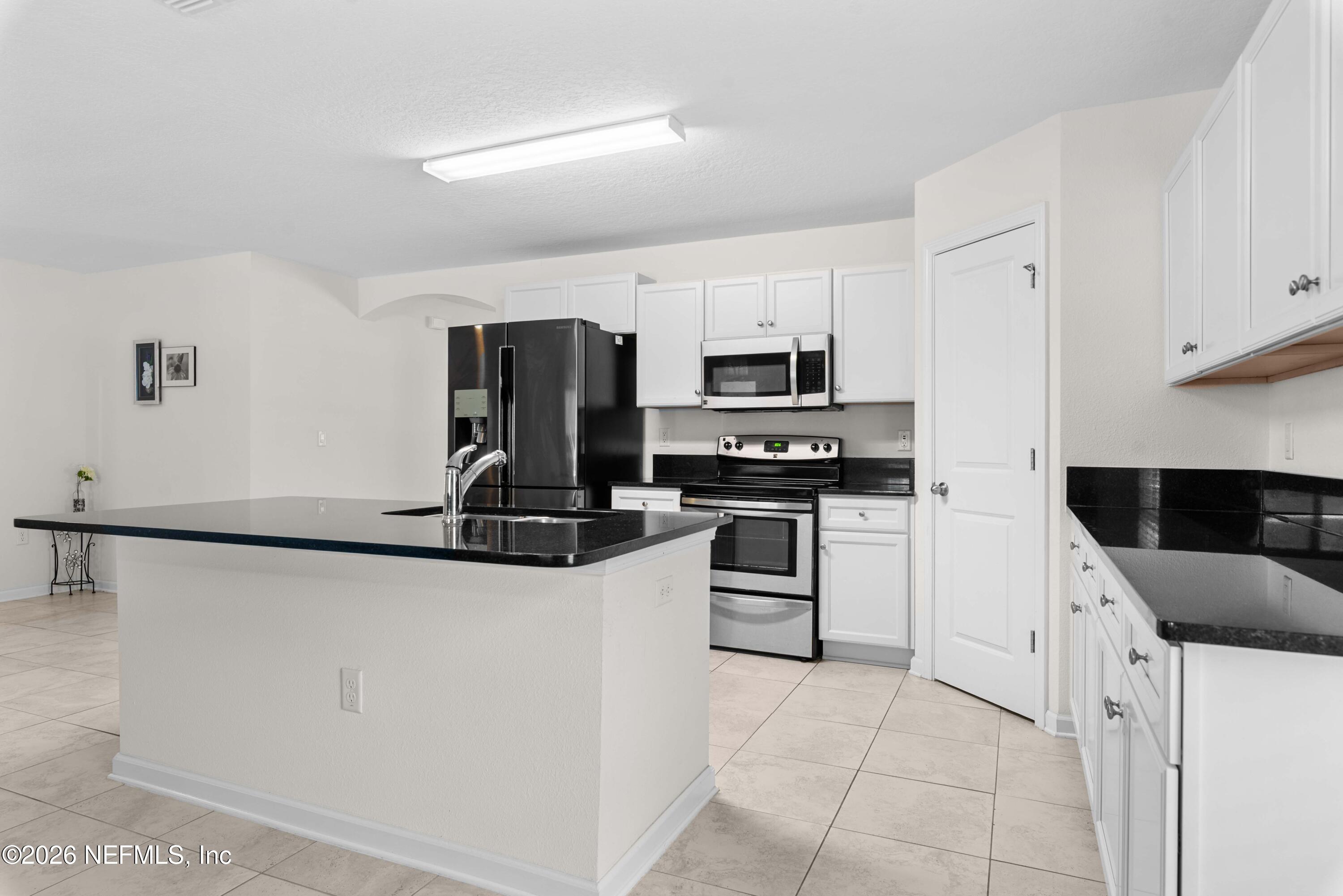 9862 Soldier Court Jacksonville, FL 32221 - Photo 12 of 30 a kitchen with granite countertop white cabinets and stainless steel appliances