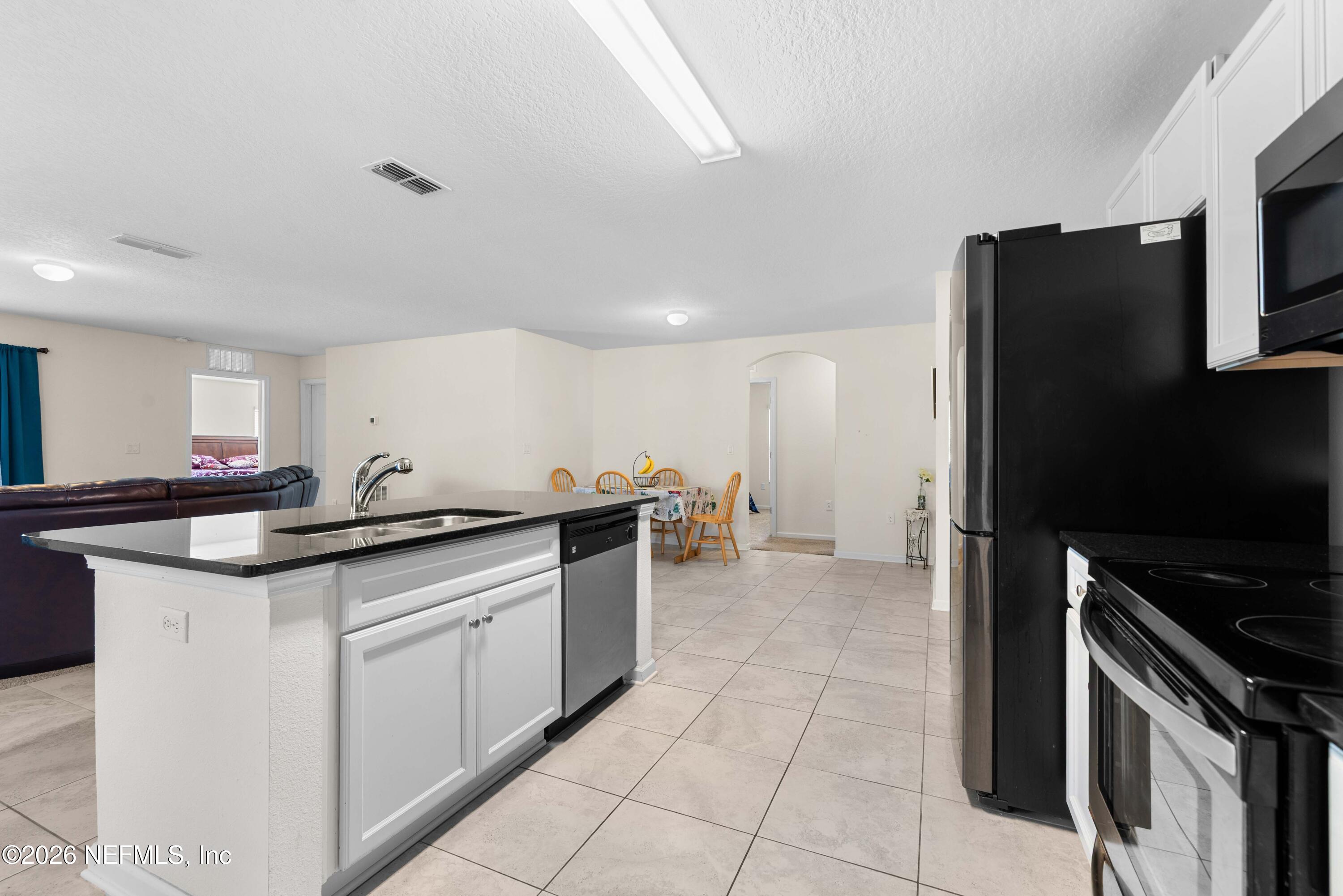 9862 Soldier Court Jacksonville, FL 32221 - Photo 14 of 30 a kitchen with stainless steel appliances granite countertop a stove a sink and a refrigerator